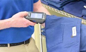 man using barcode scanning technology on nurse scrubs